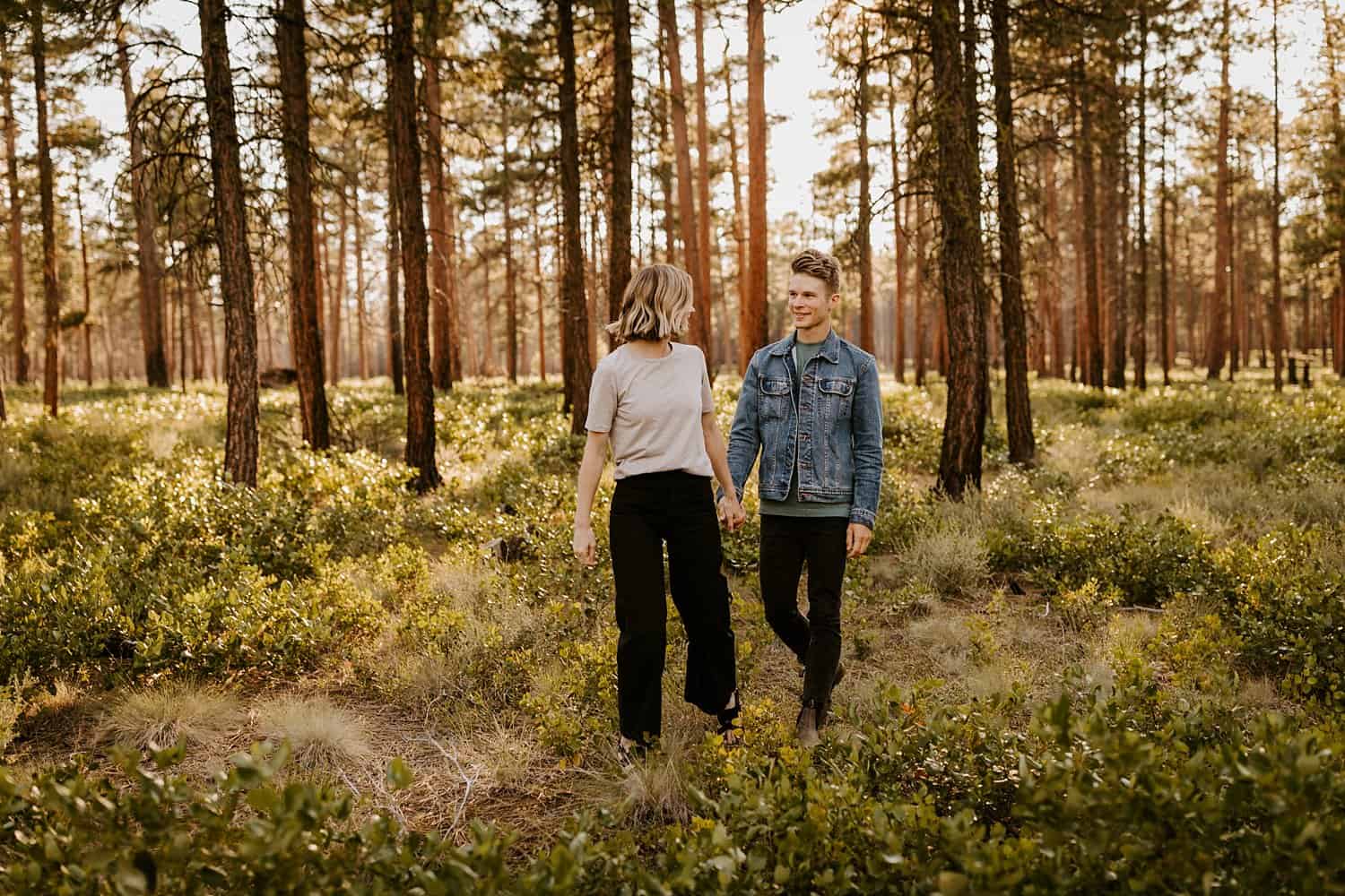 Engaged couple in high desert forest in Central Oregon